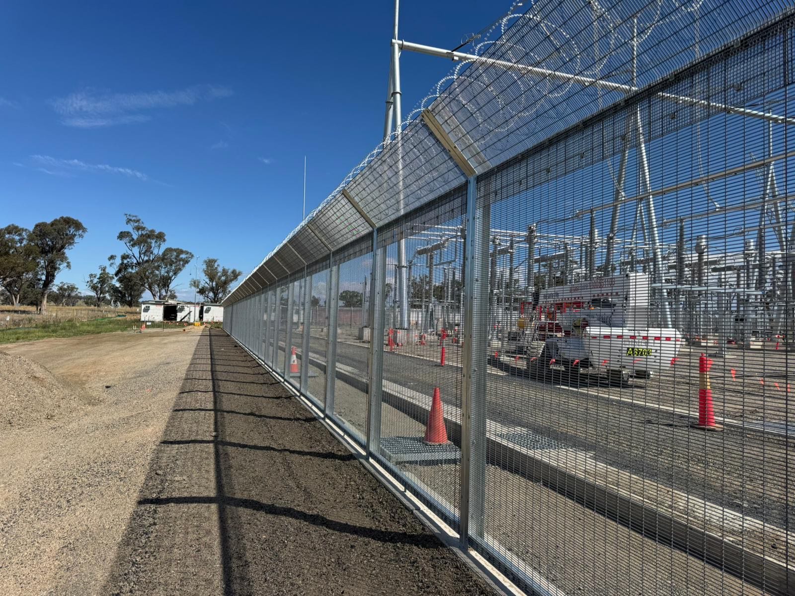 Substation perimeter in 358 mesh with razor wire topping and automated gate, May 2026